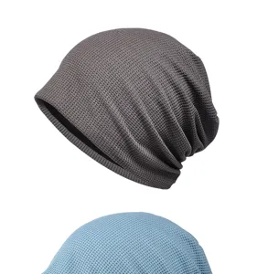 Detail of waffle knit slouchy beanies in grey and blue with soft breathable texture