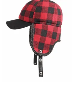 Close-up of a red and black buffalo plaid winter hat featuring warm fleece-lined ear flaps