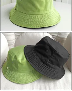 Detailed view of lime green and black bucket hats showing stitching and canvas texture.