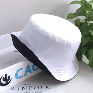Detailed view of a reversible white and black sun protection bucket hat for outdoors