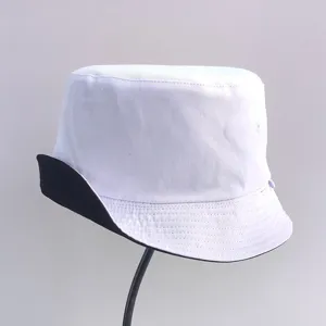 Detail view of a reversible white and black cotton bucket hat for outdoor sun protection