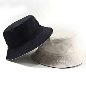 Set of two casual cotton bucket hats in black and beige for outdoor sun protection.