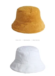 Detail view showing ginger and white plush faux fur bucket hats for winter warmth.