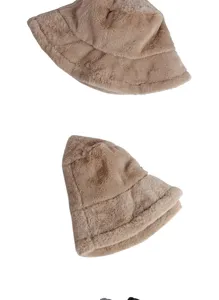 Macro shot of the thick and soft beige faux fur material on a stylish winter bucket hat