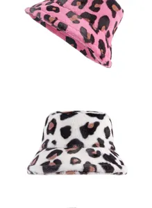 Macro detail view of two stylish faux fur leopard print bucket hats for winter.
