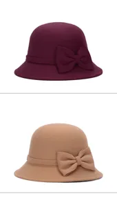 Vintage style wool-like cloche hats in burgundy and camel featuring elegant bow accents.