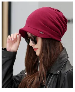 Detailed view of a fashionable women's burgundy brimmed beanie hat worn by an Asian model