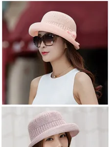 Close-up of pink knitted bucket hat showing elegant texture and bow detail