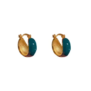 Close-up detail of vintage U-shaped hoop earrings with teal and brown enamel finish