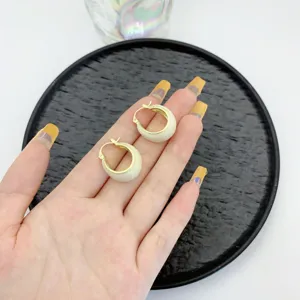 Vintage gold-tone U-shaped hoop earrings with cream enamel finish for elegant look