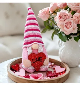Valentine's Day faceless gnome doll holding a red glittery heart with LOVE text