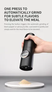 Close-up of automatic electric salt and pepper grinder grinding onto a white plate.