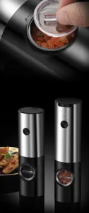 Close-up detail of filling an electric salt and pepper grinder with pink Himalayan sea salt