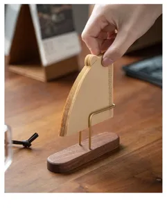 Elegante soporte para filtros de café de nogal y latón sobre una mesa de madera detalle