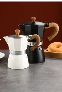 Close-up of two classic Moka pots in black and white colors with vintage wooden handles