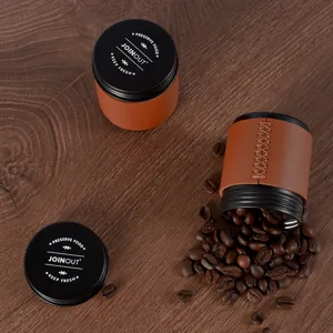 Tarros de almacenamiento de granos de café con funda de cuero marrón y tapa de metal