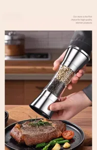 Manual dual-head stainless steel pepper grinder seasoning a delicious grilled steak