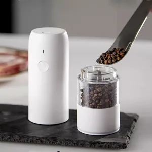 Minimalist white electric pepper and spice grinder mill with transparent storage