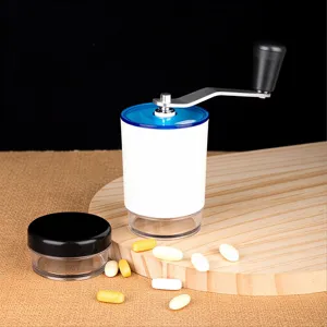 Portable manual pill grinder displayed on a wooden board with medicine tablets for daily use