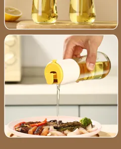 Action shot of a glass oil dispenser pouring liquid onto a delicious meal in a kitchen.