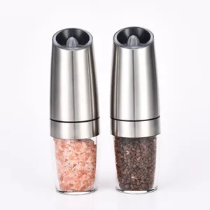 Macro view of two premium stainless steel electric gravity salt and pepper grinders