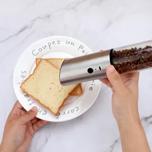 Detailed macro view of a USB electric salt and pepper grinder in a kitchen setting.