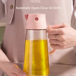 Automatic gravity glass oil dispenser bottle with ergonomic pink handle for kitchen use