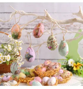 Macro detail view of Easter egg hanging ornaments with rabbit and floral prints on branches