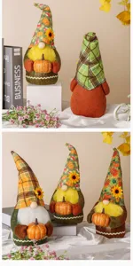 Detail view of autumn fall gnome plush dolls holding pumpkins for festive home decor