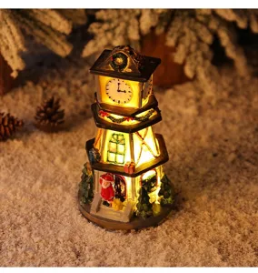 Macro view of lighted resin Christmas clock tower with Santa Claus and festive decor.