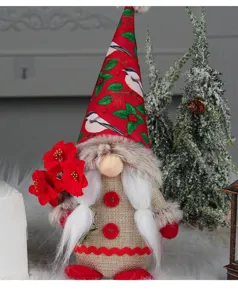 Close-up detail of a festive Christmas gnome doll featuring a printed bird pattern hat