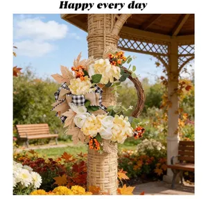 Autumn artificial flower wreath door hanging decoration with warm light and plaid bow.