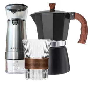 Italian coffee set featuring a black Moka pot, electric grinder, and ribbed glass cup