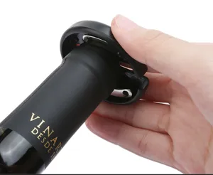 Macro detail shot of a professional black handheld wine foil cutter removing bottle seal