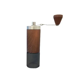 Manual coffee grinder with wood grain finish, stainless steel top, and transparent base.