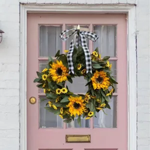 Artificial sunflower wreath with black and white plaid bow for front door decor