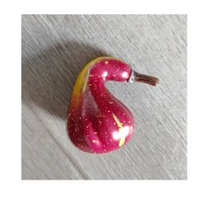 Close-up of artificial foam gourd decoration with reddish-pink and yellow speckles