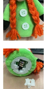 Detailed view of a green Halloween gnome plush showing the internal battery compartment