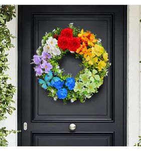 Detailed view of rainbow artificial flower wreath hanging on a modern black door