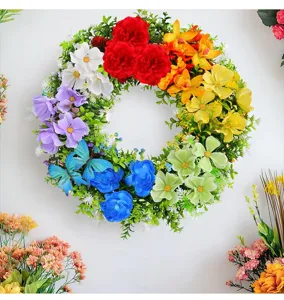 Detailed view of a vibrant rainbow-colored artificial flower wreath door hanging decoration