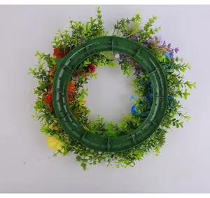 Rear view detail of colorful artificial flower wreath with green plastic frame base