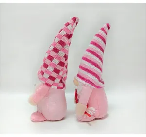 Detailed side view of two pink Valentine's Day gnomes with striped and checkered hats
