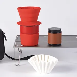Portable camping coffee drip set featuring red silicone dripper and paper filters