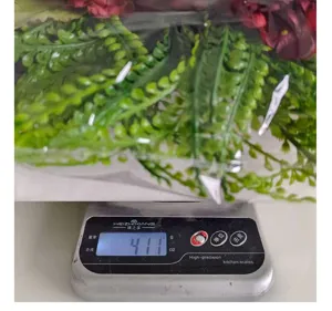 Measurement detail of artificial hydrangea wreath showing a weight of 411 grams on a scale