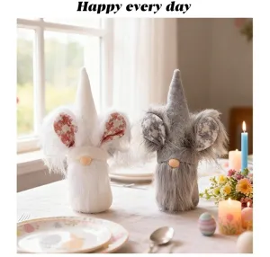 Two cute Easter faceless gnome dolls with bunny ears displayed on a decorated dining table.