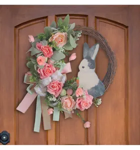 Detailed view of Easter wreath with pink roses and cute bunny cutout on wood door