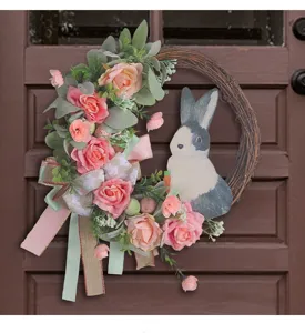Close-up of Easter door wreath with pink roses, rabbit figure and elegant ribbons