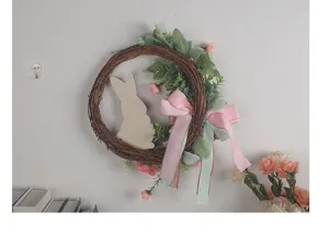 Detailed side view of an Easter rabbit grapevine wreath featuring pink ribbons and flowers