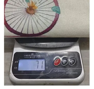 Close-up showing the weight of a colorful decorative pillowcase at exactly 71 grams