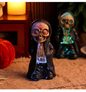 Macro view showing the glowing ribcage and eyes of this resin Halloween skeleton figurine